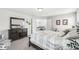 Spacious bedroom with elegant furnishings, a large window, and a calming color palette, offering a tranquil retreat at 7901 Apalachee Dr, Indianapolis, IN 46217