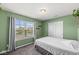 Inviting bedroom featuring a large window for natural light and neutral-toned walls with carpeting throughout at 7901 Apalachee Dr, Indianapolis, IN 46217
