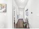 Inviting hallway with hardwood floors, neutral walls, and decorative accents and lots of natural light at 7901 Apalachee Dr, Indianapolis, IN 46217