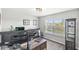 Well-lit home office featuring dual monitors, a comfortable workspace, and large window with natural light at 7901 Apalachee Dr, Indianapolis, IN 46217