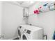 Functional laundry room featuring a modern washer and dryer set with overhead shelving for storage solutions at 7901 Apalachee Dr, Indianapolis, IN 46217
