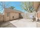 Enclosed backyard featuring a concrete patio and a small storage shed at 8116 Cheswick Dr, Indianapolis, IN 46219