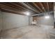 Unfinished basement featuring exposed wooden ceiling beams and a concrete floor at 8116 Cheswick Dr, Indianapolis, IN 46219