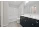 Clean bathroom with a modern vanity, tiled floors, and a shower-tub combo at 8116 Cheswick Dr, Indianapolis, IN 46219