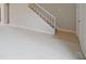 Open concept living area with plush carpeting and a staircase at 8116 Cheswick Dr, Indianapolis, IN 46219