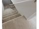 Carpeted stairs with a white handrail leading down to the basement at 8116 Cheswick Dr, Indianapolis, IN 46219