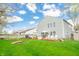 Spacious backyard featuring a deck, a well-maintained lawn, and mature trees, perfect for outdoor gatherings at 853 Westpointe Dr, Shelbyville, IN 46176