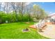 A well-manicured backyard includes a deck, comfortable seating, and lush landscaping, creating a serene outdoor space at 853 Westpointe Dr, Shelbyville, IN 46176