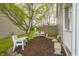 A cozy backyard nook features comfortable seating, mulched area and mature trees, providing a peaceful retreat at 853 Westpointe Dr, Shelbyville, IN 46176