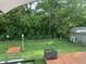A backyard provides a serene outdoor space, highlighted by lush trees, a wooden bridge, and a cozy seating area at 853 Westpointe Dr, Shelbyville, IN 46176