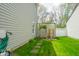 A serene backyard featuring a lush lawn, charming garden gate, and decorative fountain, creating a peaceful outdoor space at 853 Westpointe Dr, Shelbyville, IN 46176