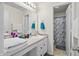 Well-lit bathroom featuring white cabinetry, a sink, and a marble pattern shower at 853 Westpointe Dr, Shelbyville, IN 46176