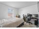Bright bedroom with a bed, desk with computer monitors, and ample natural light at 853 Westpointe Dr, Shelbyville, IN 46176