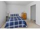 Comfortable bedroom featuring a bed with a blue and white quilt and a dresser at 853 Westpointe Dr, Shelbyville, IN 46176