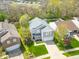 Aerial view of a charming two-story home with a well-maintained lawn and mature trees at 853 Westpointe Dr, Shelbyville, IN 46176