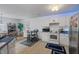 Bright kitchen featuring white cabinets, blue countertops, stainless steel appliances, and a dining area at 853 Westpointe Dr, Shelbyville, IN 46176