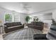 Bright living room features neutral walls, ceiling fan, and a decorative rug with two sofas at 853 Westpointe Dr, Shelbyville, IN 46176