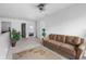 Comfortable living room with a brown couch, patterned rug, and plants at 853 Westpointe Dr, Shelbyville, IN 46176