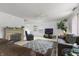 Inviting living room with a fireplace, ceiling fan, and a decorative rug, with a large sofa at 853 Westpointe Dr, Shelbyville, IN 46176