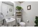 Quaint powder room featuring wallpaper accents and a pedestal sink at 853 Westpointe Dr, Shelbyville, IN 46176