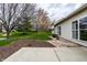 Well-maintained backyard featuring a concrete patio, manicured garden beds, and stone path at 8618 Turnstone Ct, Indianapolis, IN 46234