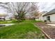 Expansive backyard with pond, lush green grass, and mature trees, creating a serene outdoor space at 8618 Turnstone Ct, Indianapolis, IN 46234