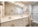 Bright bathroom features double sinks, vanity, and tiled shower with grab bars, providing a functional and accessible space at 8618 Turnstone Ct, Indianapolis, IN 46234