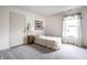Well-lit bedroom features a single bed, carpet, and window with valance at 8618 Turnstone Ct, Indianapolis, IN 46234