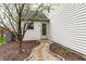 Exterior side view with a charming pathway and landscaped garden beds, enhancing curb appeal at 8618 Turnstone Ct, Indianapolis, IN 46234