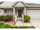 Inviting brick home featuring a charming front porch and well-maintained landscaping, a warm welcome to visitors at 8618 Turnstone Ct, Indianapolis, IN 46234