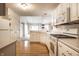 Bright kitchen with white cabinetry, modern appliances, and hardwood flooring, ideal for culinary enthusiasts and Gathering gatherings at 8618 Turnstone Ct, Indianapolis, IN 46234