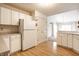 Well-lit kitchen featuring white cabinets, modern appliances, and an open layout that enhances the space's functionality at 8618 Turnstone Ct, Indianapolis, IN 46234