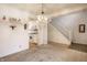 Cozy living room with a traditional chandelier, open to the kitchen and staircase, creating a connected living space at 8618 Turnstone Ct, Indianapolis, IN 46234