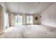 Expansive living room with vaulted ceiling, large windows, and a view of a pond creates a serene and inviting atmosphere at 8618 Turnstone Ct, Indianapolis, IN 46234