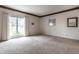 Well-lit living room with large window, neutral carpet, and traditional molding offers a cozy and inviting space at 8618 Turnstone Ct, Indianapolis, IN 46234