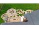 Aerial view of the backyard featuring a stone patio with a firepit, rock waterfall, and beautiful landscaping at 8842 Rocky Ridge Rd, Indianapolis, IN 46217