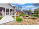 Backyard view of a charming screened porch, rock waterfall, and lush landscaping, creating a tranquil outdoor oasis at 8842 Rocky Ridge Rd, Indianapolis, IN 46217