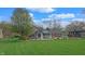 Lush backyard view showcasing a well-manicured lawn, landscaped garden beds, and a charming brick home exterior at 8842 Rocky Ridge Rd, Indianapolis, IN 46217