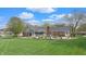 Expansive backyard with lush green grass, mature trees, and a patio area, perfect for outdoor entertaining at 8842 Rocky Ridge Rd, Indianapolis, IN 46217