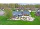Aerial view of the backyard with a patio, landscaping, and mature trees at 8842 Rocky Ridge Rd, Indianapolis, IN 46217