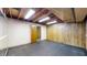 Unfinished basement space offering rubber flooring, wooden walls, and ample storage or renovation potential at 8842 Rocky Ridge Rd, Indianapolis, IN 46217