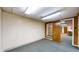 Finished basement room with white walls and classic green plaid carpeting leading to another room at 8842 Rocky Ridge Rd, Indianapolis, IN 46217
