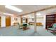 Large finished basement with a seating area, table, and built in bookshelves at 8842 Rocky Ridge Rd, Indianapolis, IN 46217