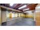 Spacious basement room with wooden walls, mirrors, and rubber flooring, perfect for a gym or workout space at 8842 Rocky Ridge Rd, Indianapolis, IN 46217