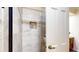 Modern bathroom with a tiled walk-in shower featuring a recessed shelf for toiletries and glass door at 8842 Rocky Ridge Rd, Indianapolis, IN 46217