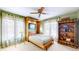 Versatile bedroom with a Murphy bed, ceiling fan, and bookshelf, ideal for guests or hobbies at 8842 Rocky Ridge Rd, Indianapolis, IN 46217