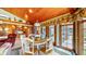 Inviting dining area featuring wood paneled ceilings, exposed brick and an abundance of natural light at 8842 Rocky Ridge Rd, Indianapolis, IN 46217
