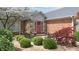 Charming brick home with a welcoming front entrance featuring decorative stone accents and manicured bushes at 8842 Rocky Ridge Rd, Indianapolis, IN 46217