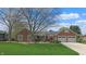 Attractive brick home with a well-maintained lawn, garage, and mature trees enhancing its curb appeal at 8842 Rocky Ridge Rd, Indianapolis, IN 46217