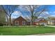 Charming brick home with a well-manicured lawn and beautiful landscaping, offering curb appeal at 8842 Rocky Ridge Rd, Indianapolis, IN 46217